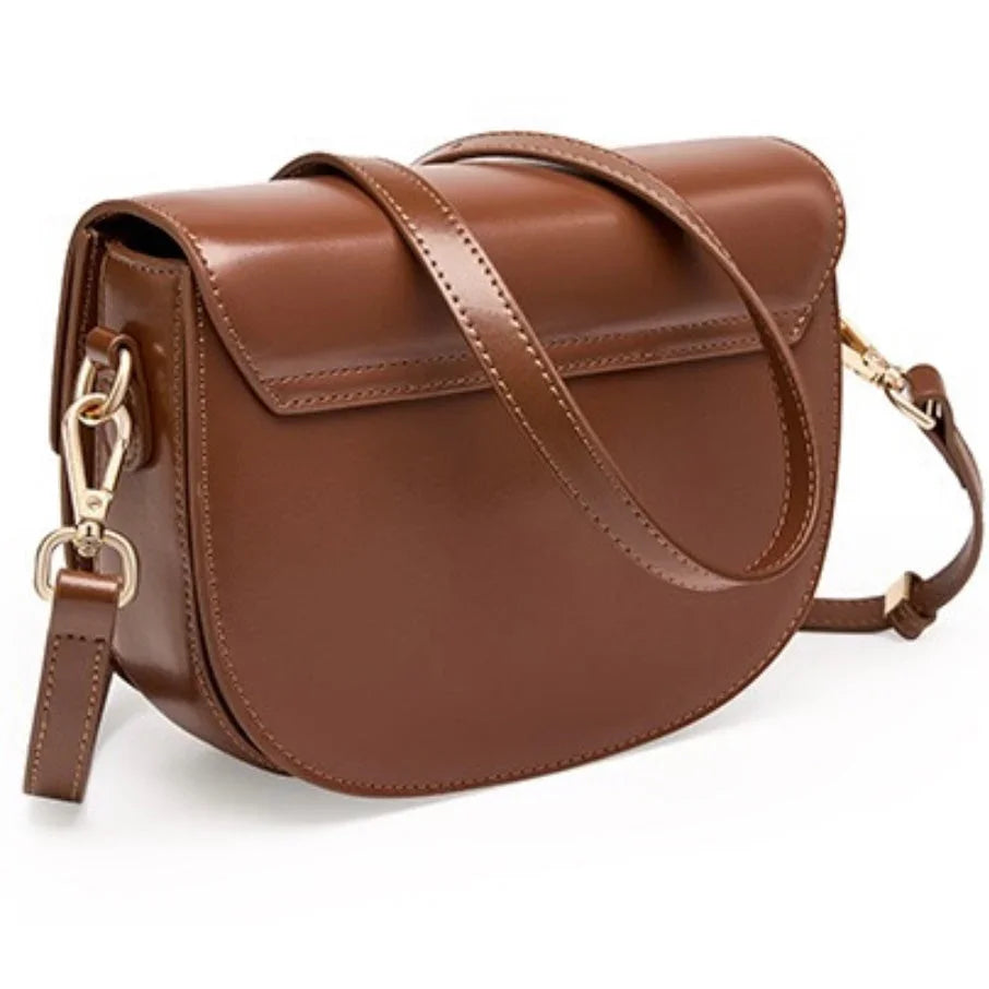 Brown leather crossbody bag with gold hardware and adjustable strap on white background