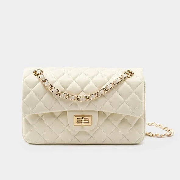 Quilted white leather handbag with gold chain strap and rectangular turn-lock clasp