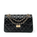 Black quilted leather handbag with gold chain strap and turn-lock closure