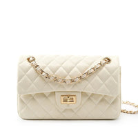 Quilted cream leather handbag with gold chain strap on white background