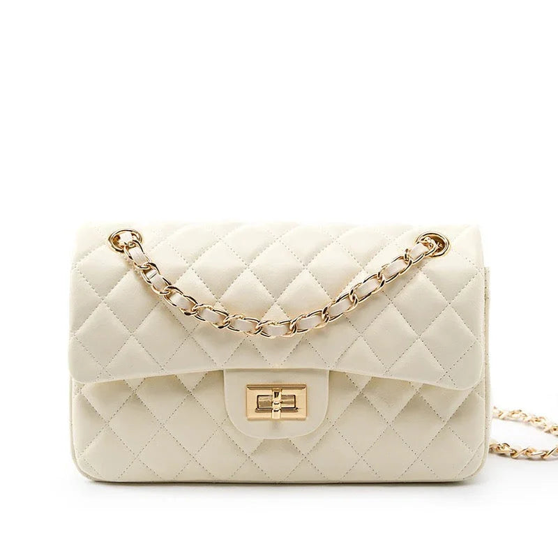 Quilted cream leather handbag with gold chain strap on white background