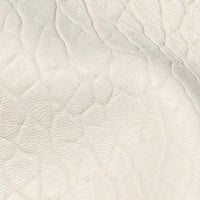Close-up of textured cream white leather surface with natural grain pattern
