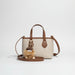 Beige and brown leather crossbody bag with plush pom pom keychain accessory
