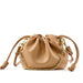 Beige leather drawstring pouch bag with gold chain and knotted straps on white background