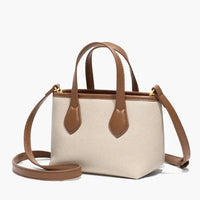 Beige and brown leather crossbody mini tote bag with top handles on white background