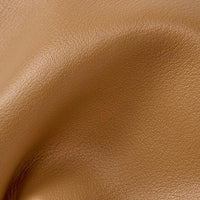 Close-up of tan brown faux leather texture with natural grain and soft folds