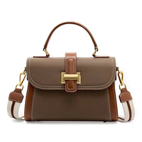 Brown leather handbag with top handle, gold hardware, and adjustable shoulder strap