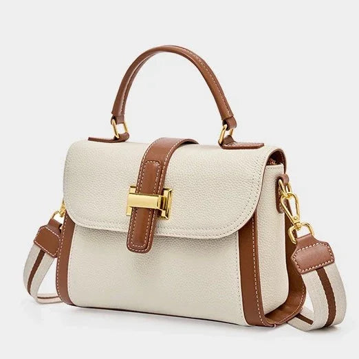 Stylish beige and brown leather handbag with gold hardware and striped shoulder strap