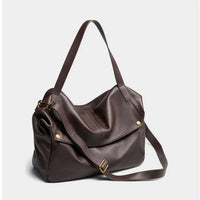 Brown leather shoulder bag with gold hardware on a plain light background