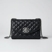 Black quilted leather shoulder bag with silver chain strap and metallic logo clasp