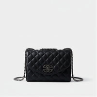 Black quilted leather handbag with chain strap and silver clasp on white background