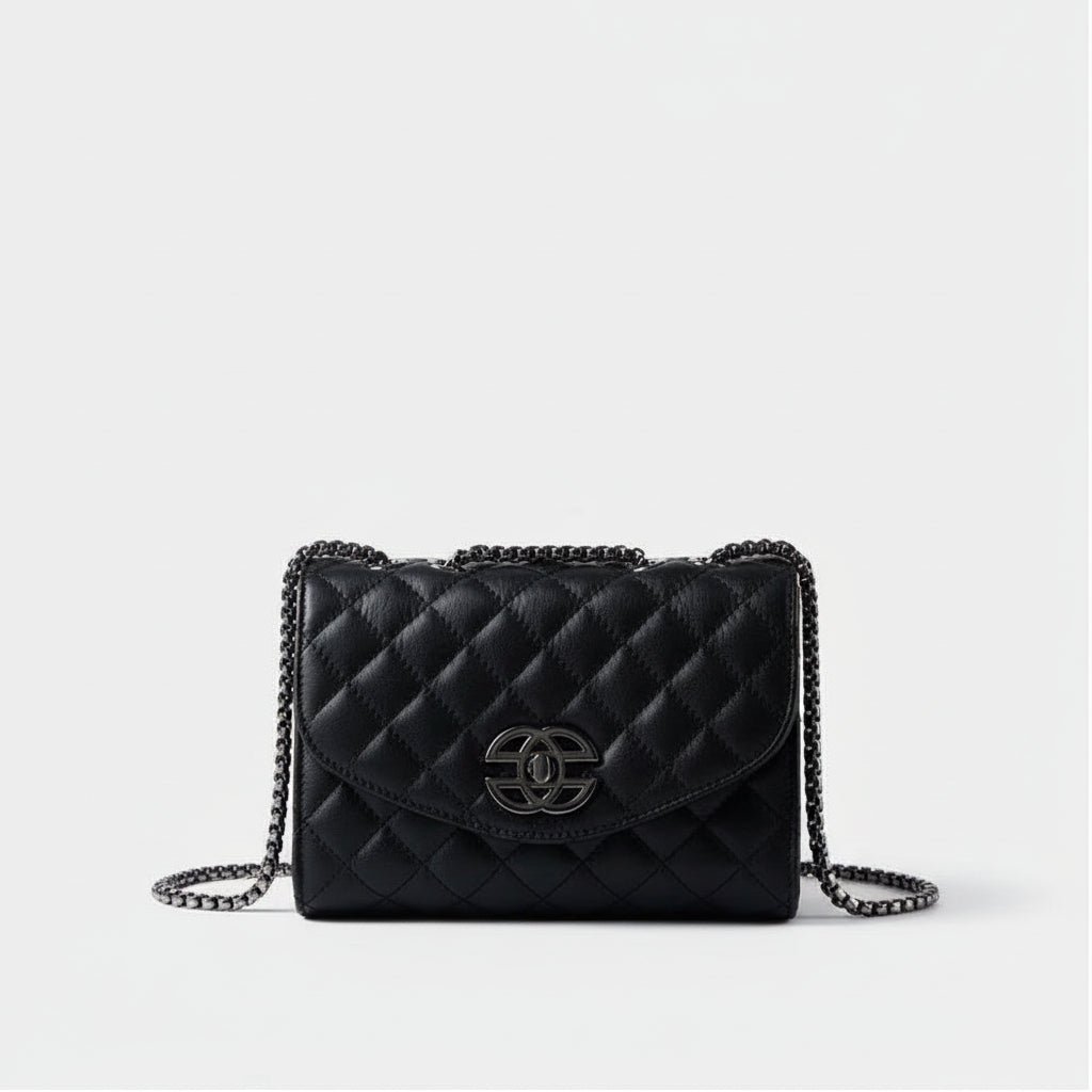 Black quilted leather handbag with chain strap and silver clasp on white background