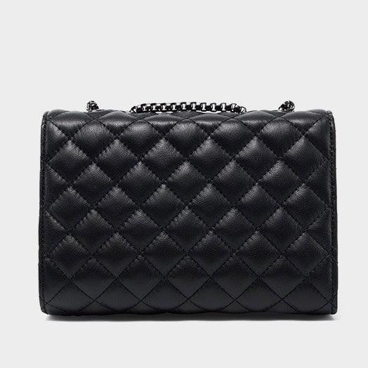 Black quilted leather handbag with chain strap on a plain gray background