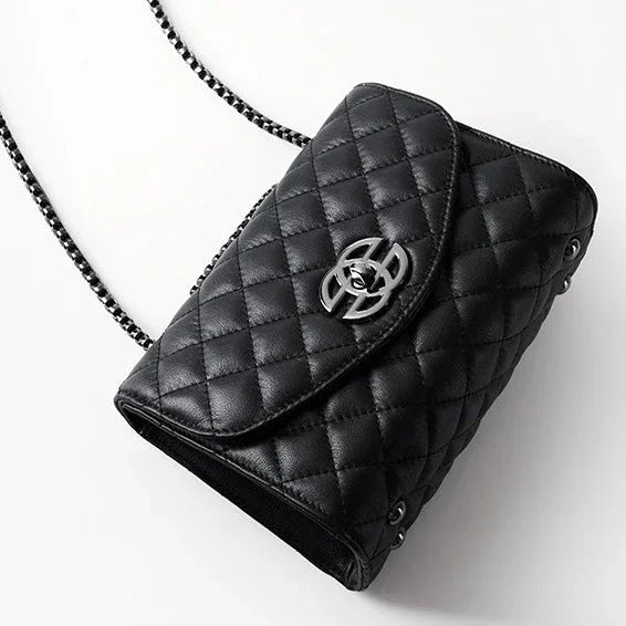Black quilted leather crossbody bag with chain strap and silver clasp on white background