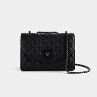 Black quilted leather shoulder bag with chain strap and metal logo on white background
