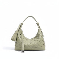 Sage green woven leather shoulder bag with top handle and zip pouch on white background