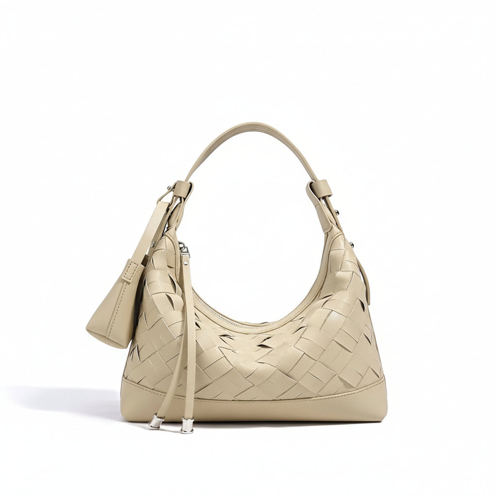 Beige woven leather shoulder bag with top handle and attached pouch on white background