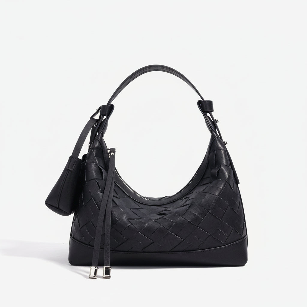 Black woven leather shoulder bag with curved handle and silver accents on white background