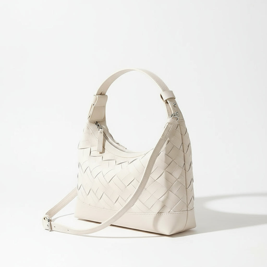 White woven leather crossbody bag with zipper on light surface