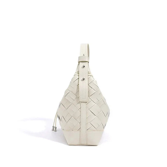 White woven leather sling bag with buckle and drawstring on white background