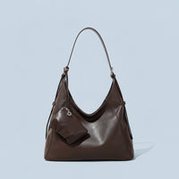 Dark brown leather hobo bag with pouch, minimalist background, stylish women's handbag