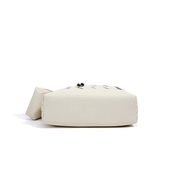 Bottom view of a white square leather handbag with geometric stitching on a white background