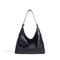 Black leather hobo shoulder bag with small attached pouch on white background