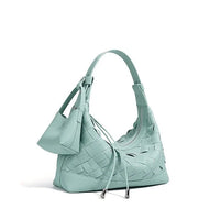 Mint green woven leather shoulder bag with drawstring and small pouch on white background