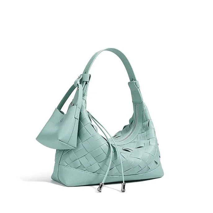 Mint green woven leather shoulder bag with drawstring and small pouch on white background
