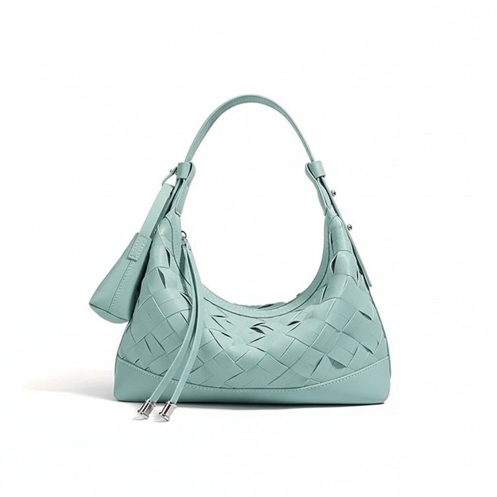 Mint green woven leather shoulder bag with zipper and matching pouch on white background