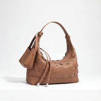 Brown woven leather shoulder bag with a small pouch against a white background