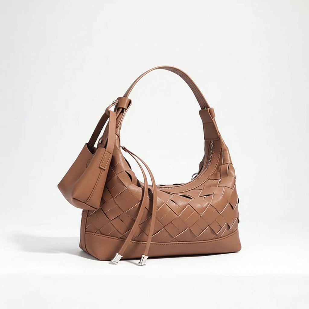 Brown woven leather shoulder bag with a small pouch against a white background