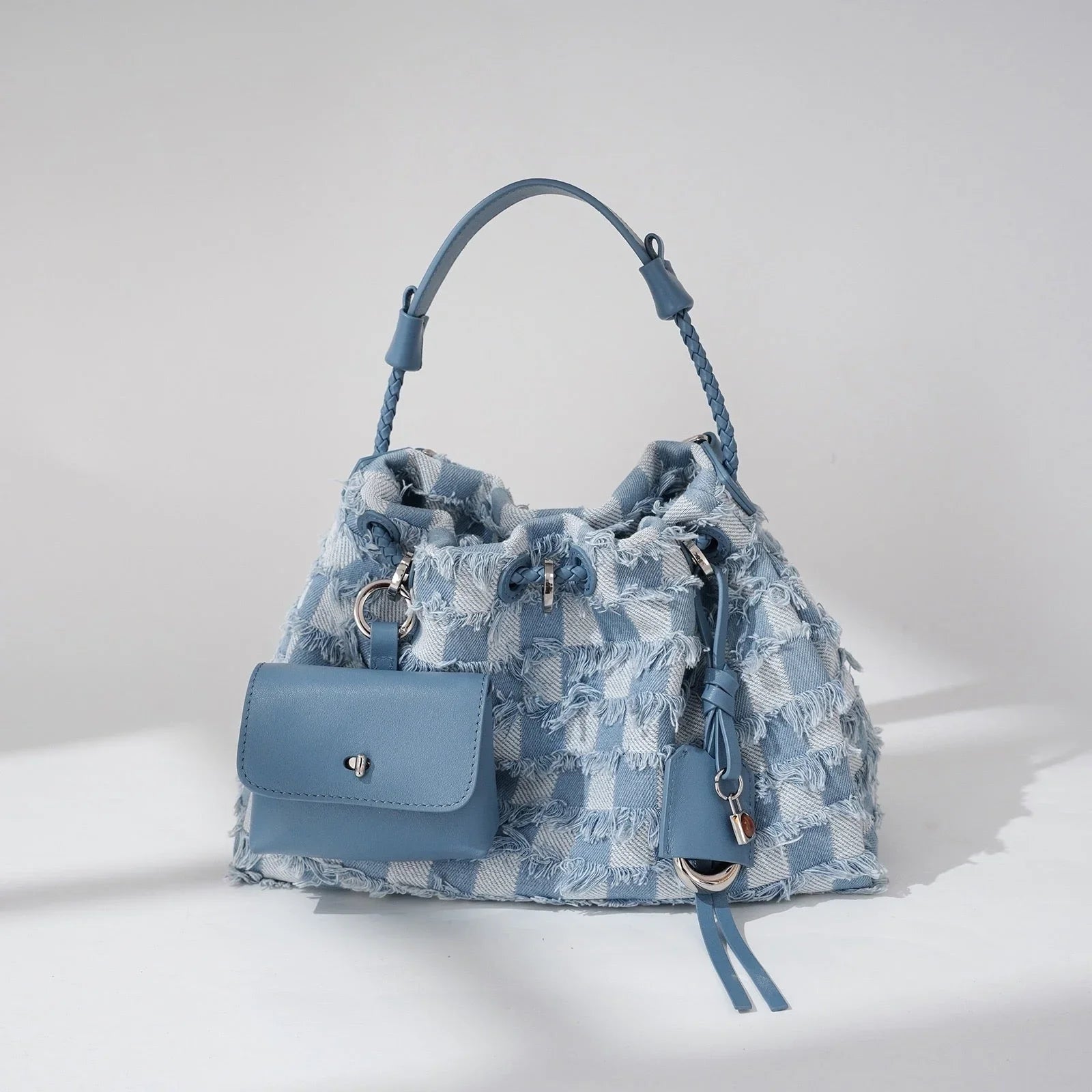 Light blue checkered denim handbag with braided handle and attached front pouch