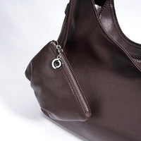 Dark brown leather handbag with zipper pocket and silver charm detail