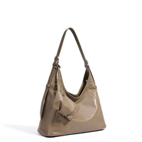 Taupe leather shoulder bag with bow detail on white background