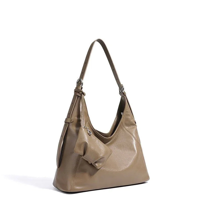 Taupe leather shoulder bag with bow detail on white background