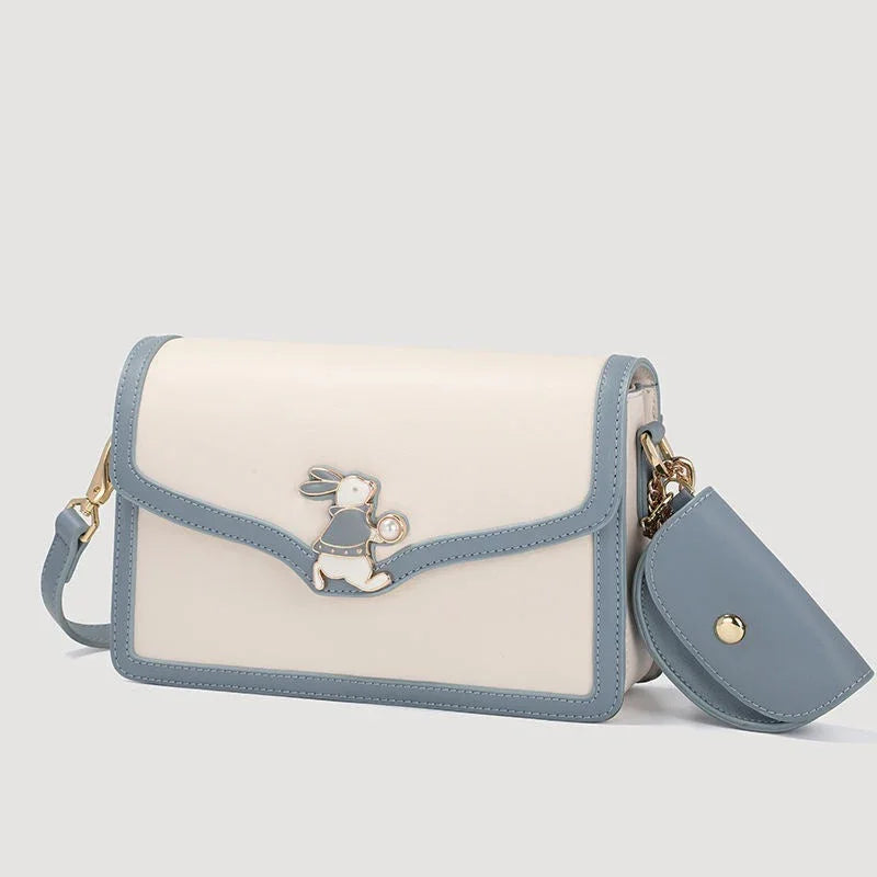 Cream and blue crossbody purse with gold bunny charm and detachable pouch