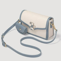 Cream and blue crossbody bag with bunny charm and matching mini pouch on strap