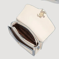 Open cream and blue leather crossbody bag with gold clasp and organized compartments