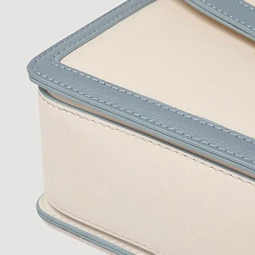 Cream and blue leather box with contrast stitching, minimalist elegant design