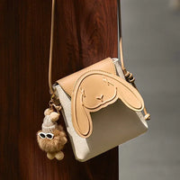 Cute beige crossbody bag with bunny face design and plush keychain accessory