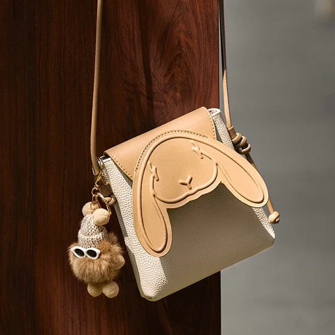 Cute beige crossbody bag with bunny face design and plush keychain accessory