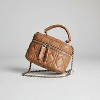 Brown quilted leather crossbody bag with chain strap on white background