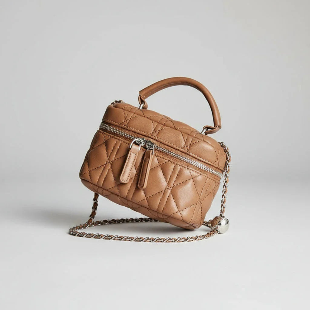 Brown quilted leather crossbody bag with chain strap on white background