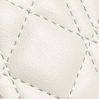 Close-up of white quilted leather texture with visible stitching detail