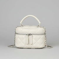 Quilted white leather handbag with top handle, silver chain strap, and front zipper on gray background