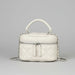 Quilted white leather handbag with top handle, silver chain strap, and front zipper on gray background