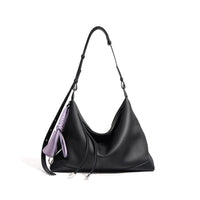 Black leather hobo shoulder bag with adjustable strap and purple tassel accent