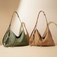 Green and tan leather hobo handbags with adjustable straps on beige background