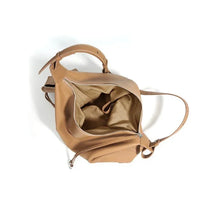 Open tan leather tote bag with beige fabric lining and zipper closure on white background